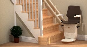 Brown stairlift at bottom of wooden stairs